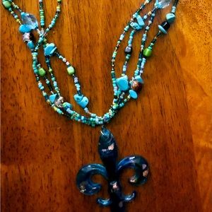 Fleur-de-lis pendant on beaded glass chain